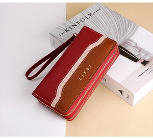 Detail of tricolor lychee grain leather wallet with double zippers and wrist strap