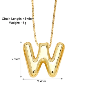 Macro detail of puffy 3D letter W pendant necklace in gold with size dimensions