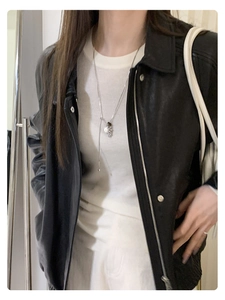 Tiger eye and pearl pendant necklace styled with a black leather jacket and white knit top