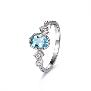 Elegant silver ring with oval sky blue topaz stone and sparkling side accents