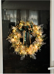 Close-up of a 40cm Christmas wreath with golden ornaments and warm LED lights