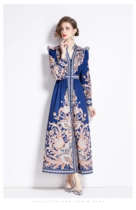 Close-up of vintage paisley print on navy blue long sleeve V-neck maxi dress fabric