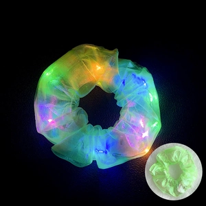 Detail view of glowing LED hair scrunchie in fluorescent green mesh with light-up effect