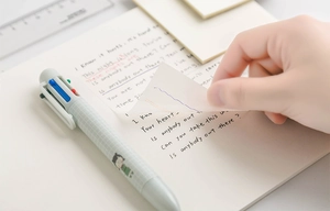 Close-up of clear PET sticky notes showing high transparency on a notebook page