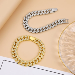 Detail of hip hop Cuban link bracelets in gold and silver with shimmering rhinestones