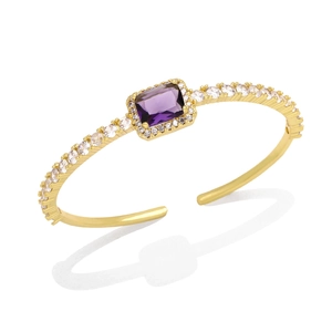 Detail of 18K gold open bangle featuring a purple rectangular stone and pavé zircons