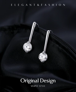 Makroaufnahme von 0,5 ct Moissanit-Ohrringen mit Silberhaken auf schwarzem Leder