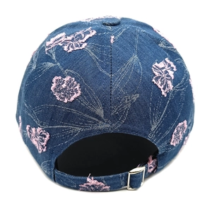 Detail view of denim baseball cap back with pink floral embroidery and metal buckle