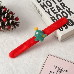 Plush red Christmas slap bracelet featuring a green Christmas tree with a yellow star topper
