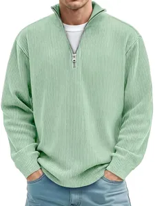 Detail of mint green ribbed polo shirt featuring a quarter-zip stand collar and textured fabric