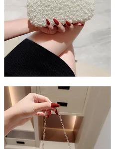 Close-up of elegant pearl evening clutch with gold chain strap and detailed pearl beadwork