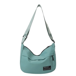 Minimalist mint green nylon half-moon crossbody tote bag with adjustable shoulder strap