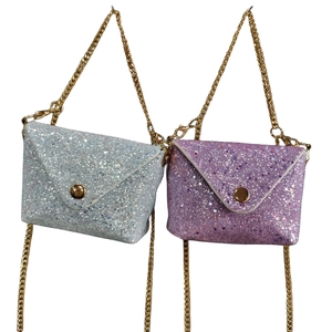 Close-up of glitter coin purses in silver and pink purple with golden metal chains
