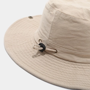Close-up of khaki outdoor hat featuring reinforced stitching and adjustable drawstring
