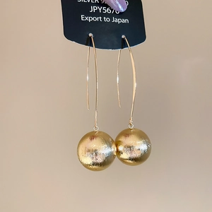 Close-up of gold brushed texture ball pendant earrings featuring S925 silver hooks