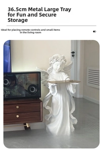 Macro view of white angel sculpture holding a 36.5cm gold metal tray for home decor