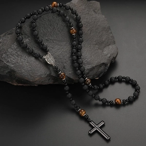 Detail of lava stone and tiger eye bead necklace with metal medal and black cross