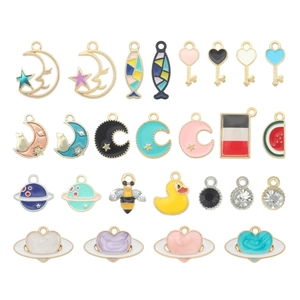 Flat lay of diverse zinc alloy enamel charms including moon, cat, and star shapes