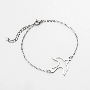 Minimalist stainless steel bracelet with cutout swallow bird pendant and 18K gold plating