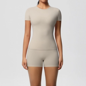 Detail of high-elasticity seamless women's yoga set with short sleeve top and gym shorts