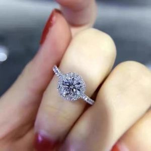 Three-piece jewelry set featuring a silver halo engagement ring with pavé round diamonds