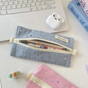 Macro shot of blue and pink star canvas pencil cases showcasing large storage capacity