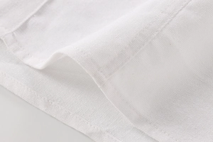 Close-up of white linen blend fabric texture and professional stitching on casual shirt