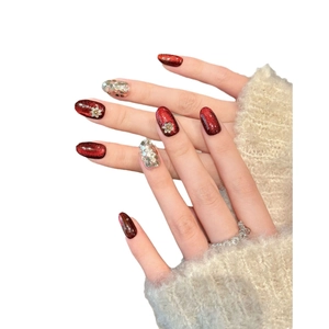 Handmade red cat-eye press-on nails with silver glitter and gold floral accents