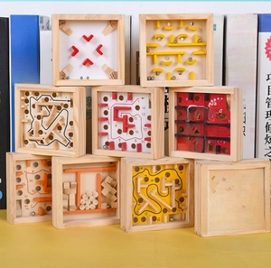 Detailed view of square wooden maze puzzle toys with metal balls and transparent panels
