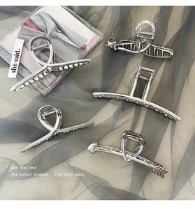 Detailed set of silver metallic claw clips in various geometric and heart-shaped designs