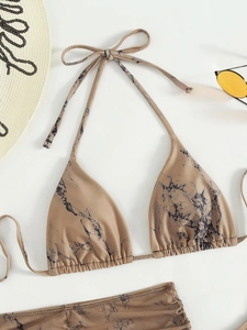 Detail of marble print halter bikini top with summer straw hat and vintage sunglasses