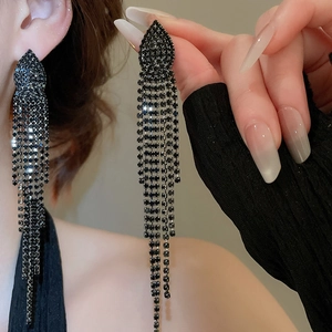 Detail of long jellyfish tassel earrings with black sparkling rhinestones and silver pins