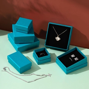Elegant cyan jewelry gift box set with matching silver necklaces, rings and earrings