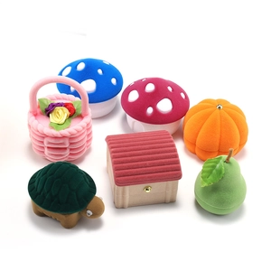 Creative velvet jewelry boxes in mushroom, pumpkin and turtle shapes on white background