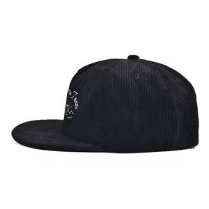 Detail of mountain embroidery and text on black corduroy flat brim baseball cap