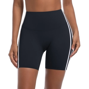 Close-up of high-waisted black yoga shorts with side double white stripes on sporty fabric