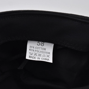 Close-up of fabric label showing 35% cotton and 65% polyester blend on black beret