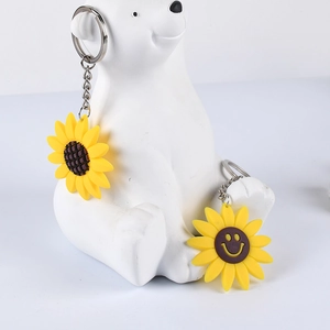 Cute PVC sunflower keychains with smiling face on a decorative bear ornament