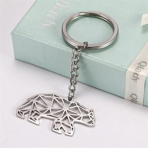 Detailed view of silver stainless steel polar bear keychain in origami geometric style