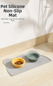 Detail showing non-slip waterproof silicone pet placemat with ceramic food bowls