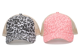 Close-up of leopard print mesh baseball caps in classic black-white and vibrant pink colors