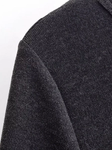 Close-up showing the shoulder seam detail and knit texture of charcoal grey dress