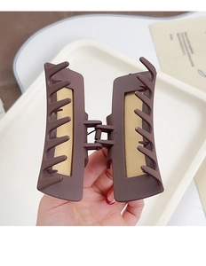 Detail of western poker print hair claw with matte brown finish and non-slip inner grip