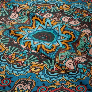Detailed view of bohemian mandala tapestry fabric showing complex patterns and rich textures