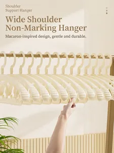 Close-up of beige wide shoulder non-slip hangers with seamless design for clothes