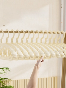 Close-up of beige wide shoulder non-slip hangers with seamless design for clothes
