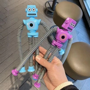 Blue and purple suction cup robot toys with extendable limbs held in hand for fun