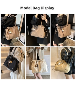 Detail view of large capacity nylon tote bag with drawstring closure and tassel charms