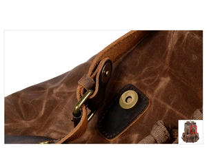 Detail of magnetic buckle closure and durable waxed canvas texture on brown backpack