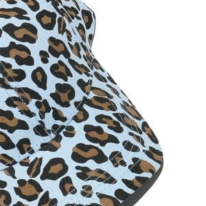 Close-up of leopard print twill cotton fabric on a light blue baseball cap